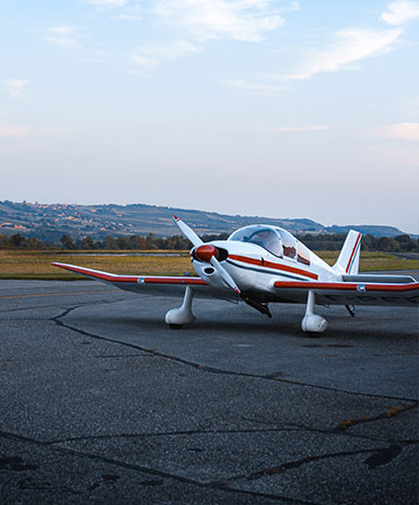 small aircraft sitting on runway