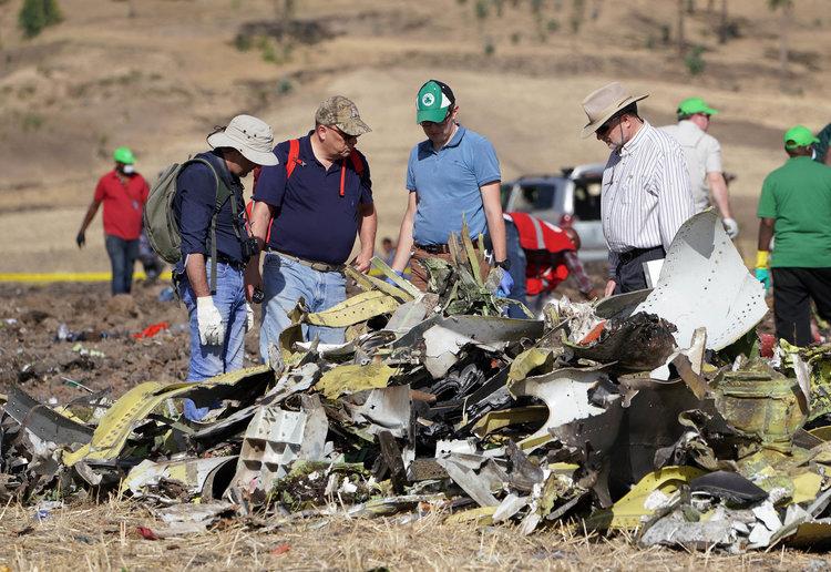 Investigators look at the debris from the crashed Ethiopian Airlines Boeing 737 Max plane in March 2019.