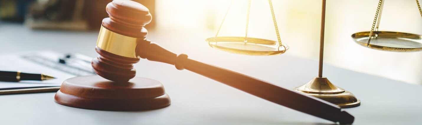 Desk with gavel, scales, statue of Lady Justice