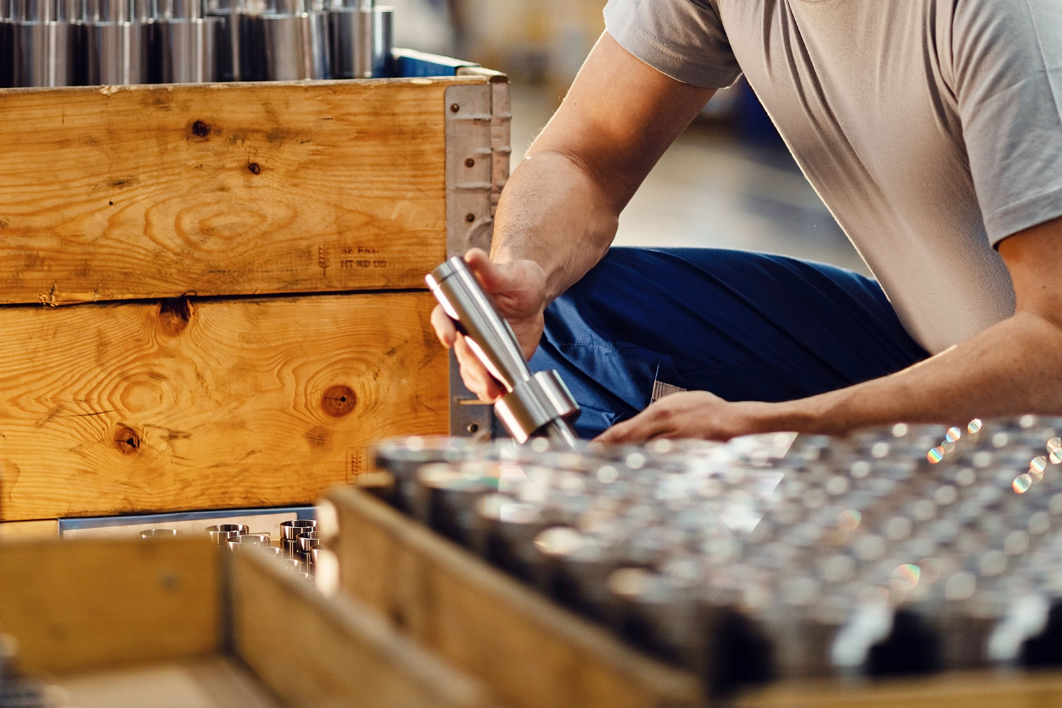 man inspecting parts in manufacturing facility