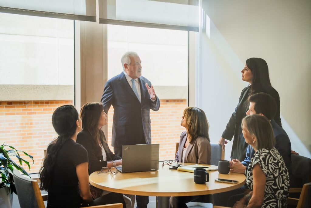 The Podhurst Orseck team having a discussion around a table.