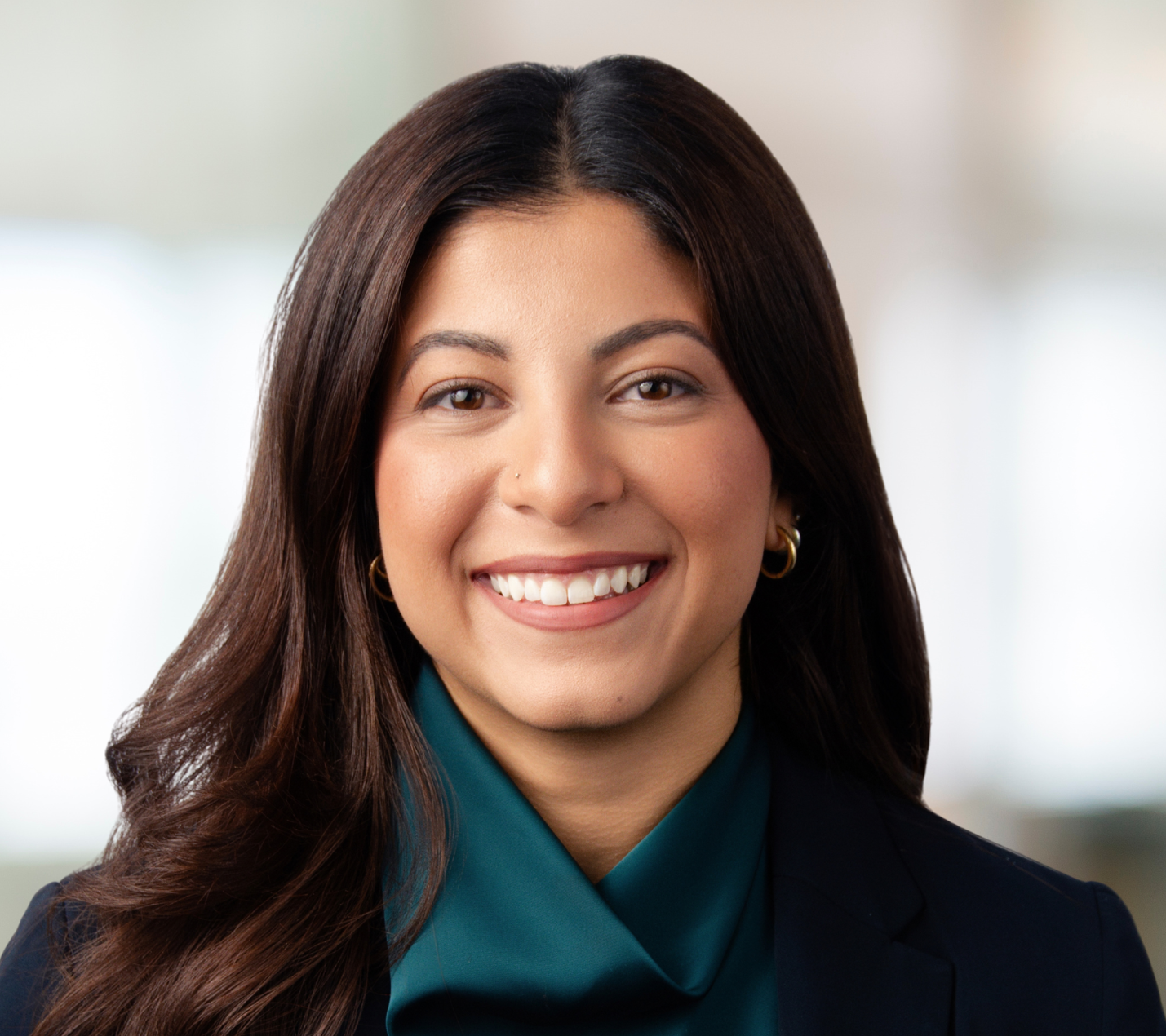 A woman with long dark hair and brown eyes